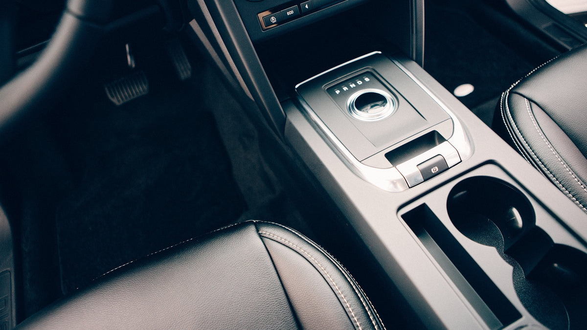 Truck centre console with gear selector, storage tray and cup holders