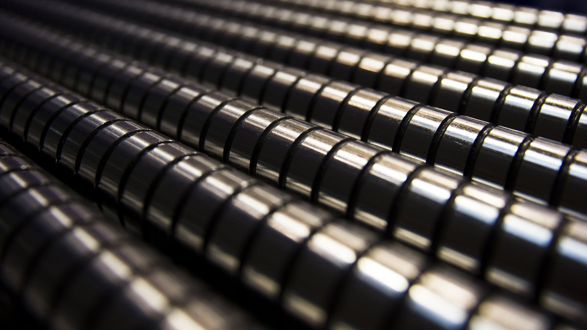 Rows of dark metallic cylinders stacked edge to edge