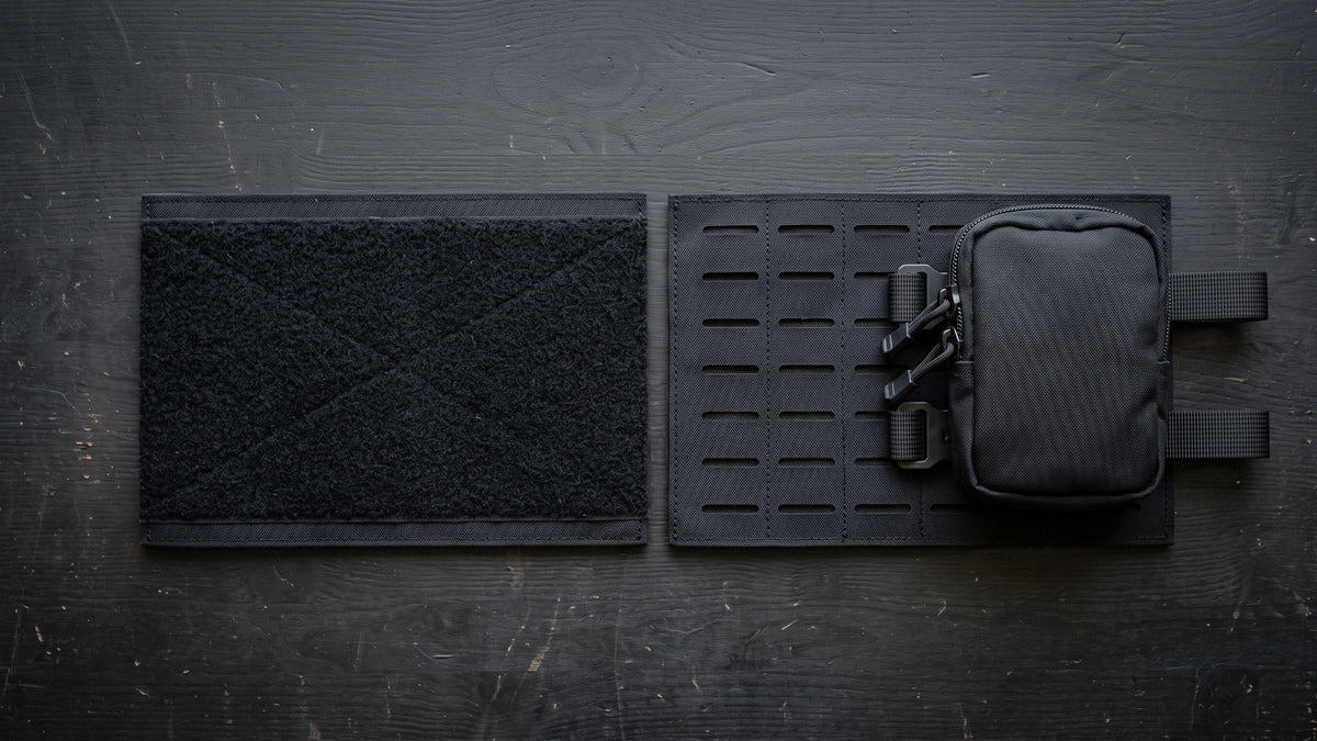 Two black nylon panels on a dark bench: a loop field and a laser-cut slot panel with a pouch woven through