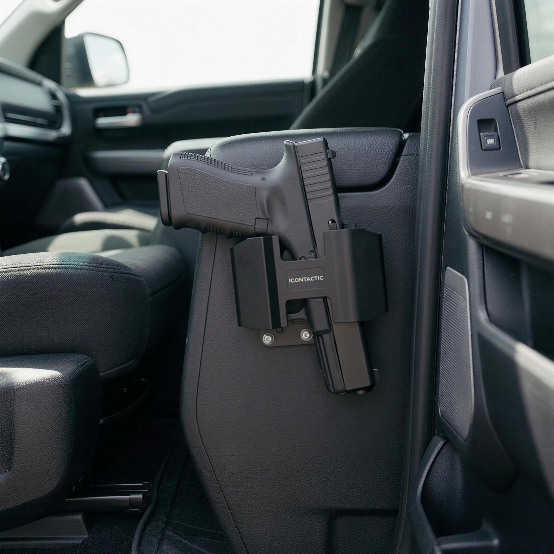 ICONTACTIC Magnetic Handgun Mount on the driver-side face of a truck center console with a pistol seated in it. Concept render pending supplier verification, illustrative