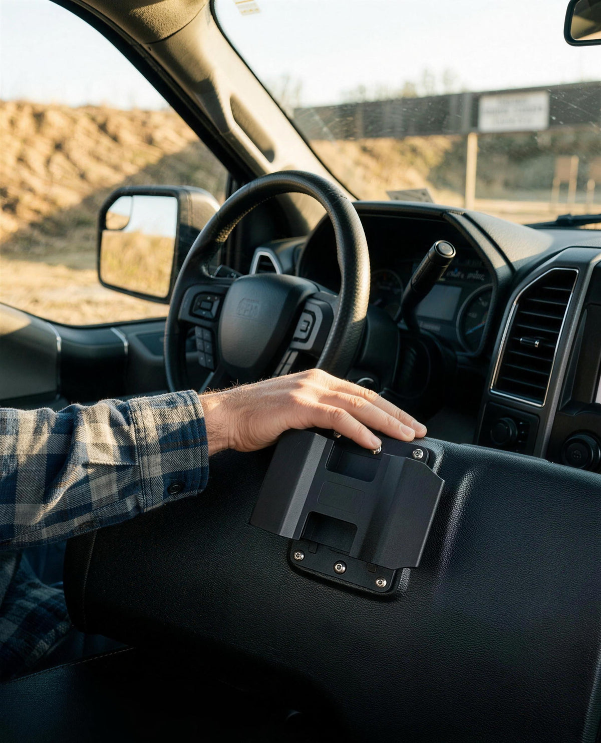 ICONTACTIC Magnetic Handgun Mount being pressed onto the driver-side face of a truck center console, no firearm. Concept render pending supplier verification, illustrative