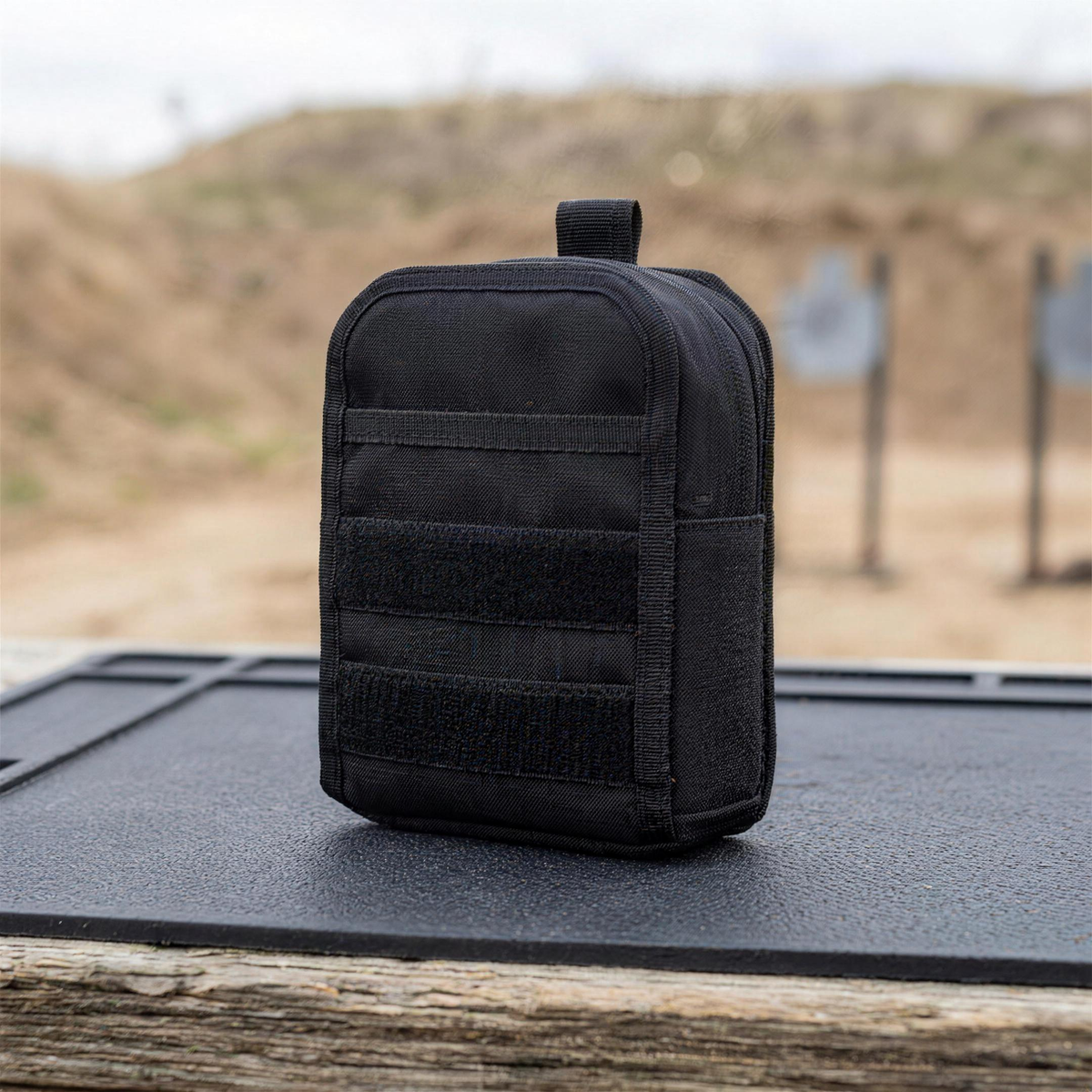 ICONTACTIC Compact Zip Organizer, concept render pending supplier verification, closed, on an outdoor range bench