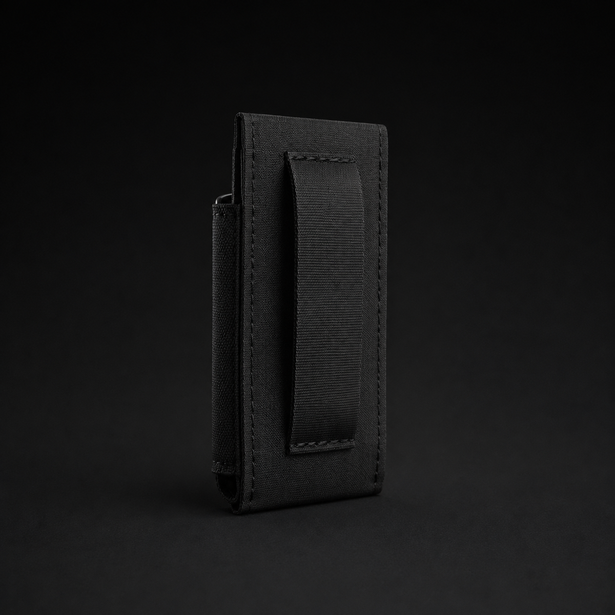 ICONTACTIC Low-Profile Single Magazine Pouch, concept render pending supplier verification, rear view showing the belt passthrough on graphite