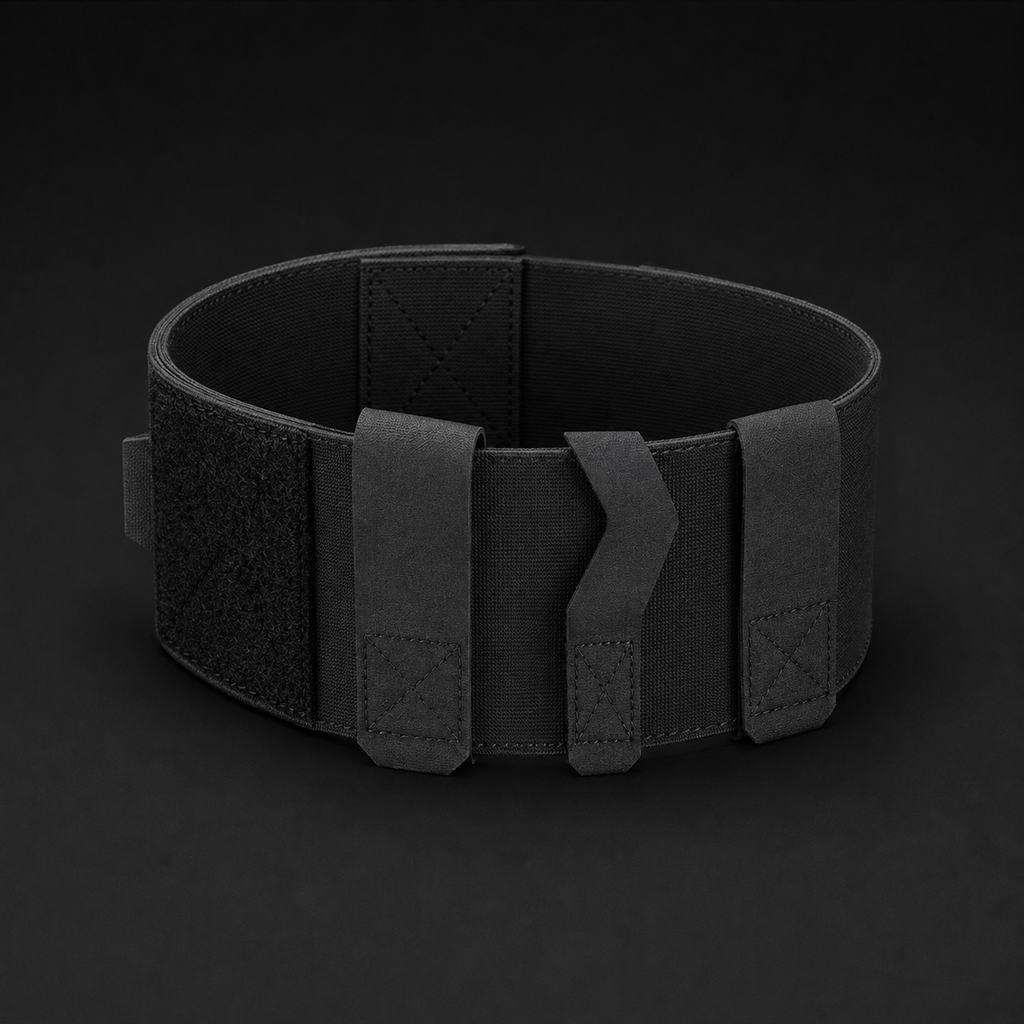 ICONTACTIC Ankle Utility Carrier, concept render pending supplier verification, empty carrier closed into a ring showing the three retention bands, on graphite