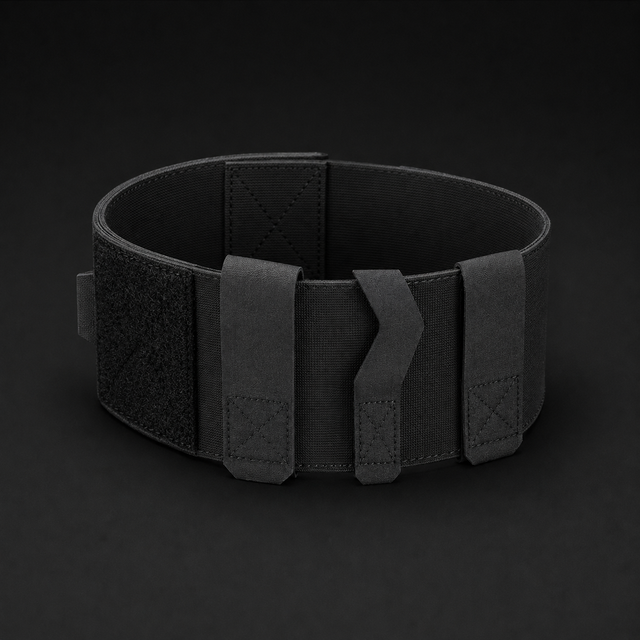 ICONTACTIC Ankle Utility Carrier, concept render pending supplier verification, empty carrier closed into a ring showing the three retention bands, on graphite