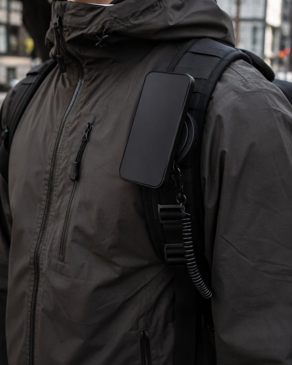 ICONTACTIC Magnetic Phone Mount for Straps and Webbing, concept render pending supplier verification, on a backpack strap holding a plain phone, illustrative