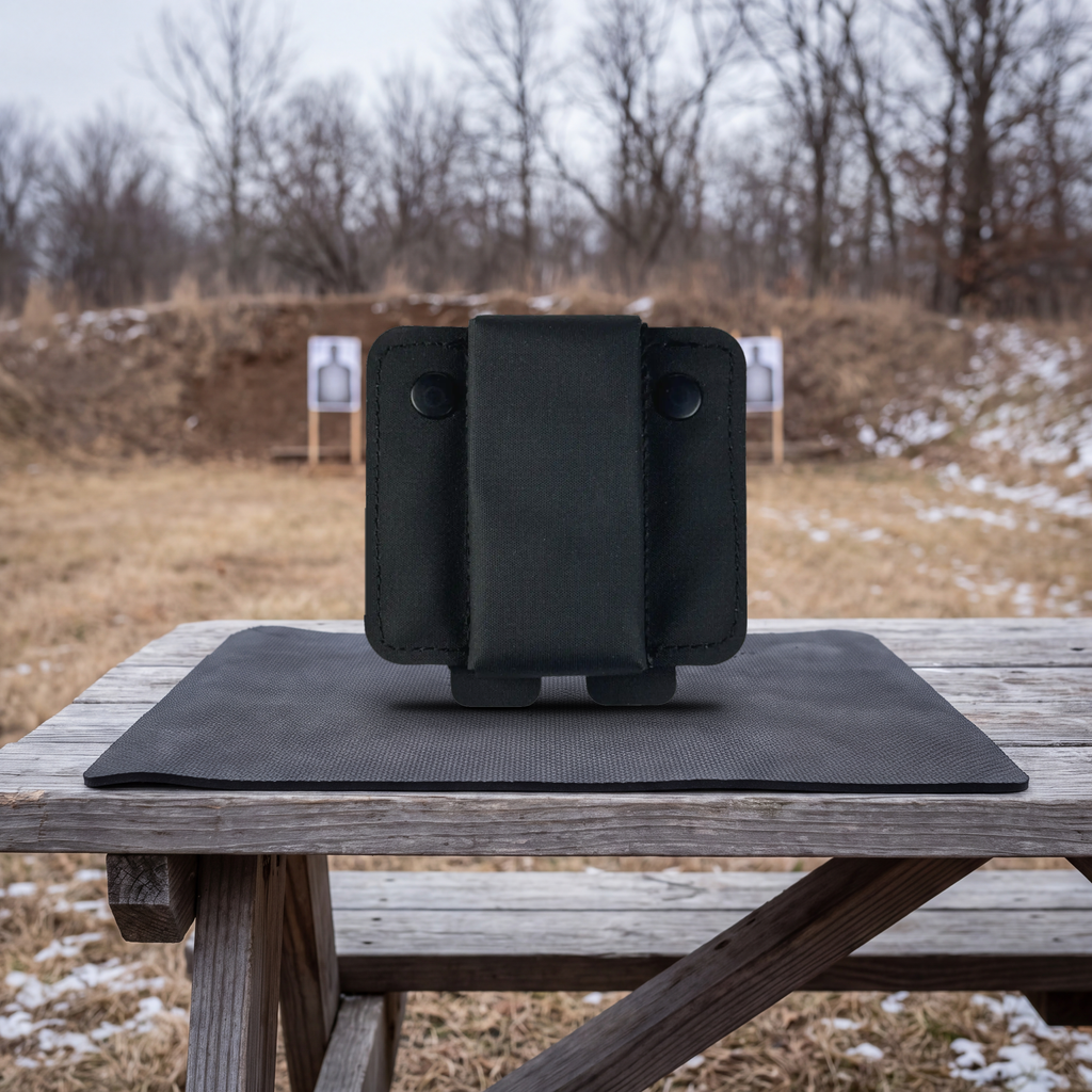 ICONTACTIC Magnetic Retention Catch, front view with the centre strap and two snap studs, on an outdoor range bench