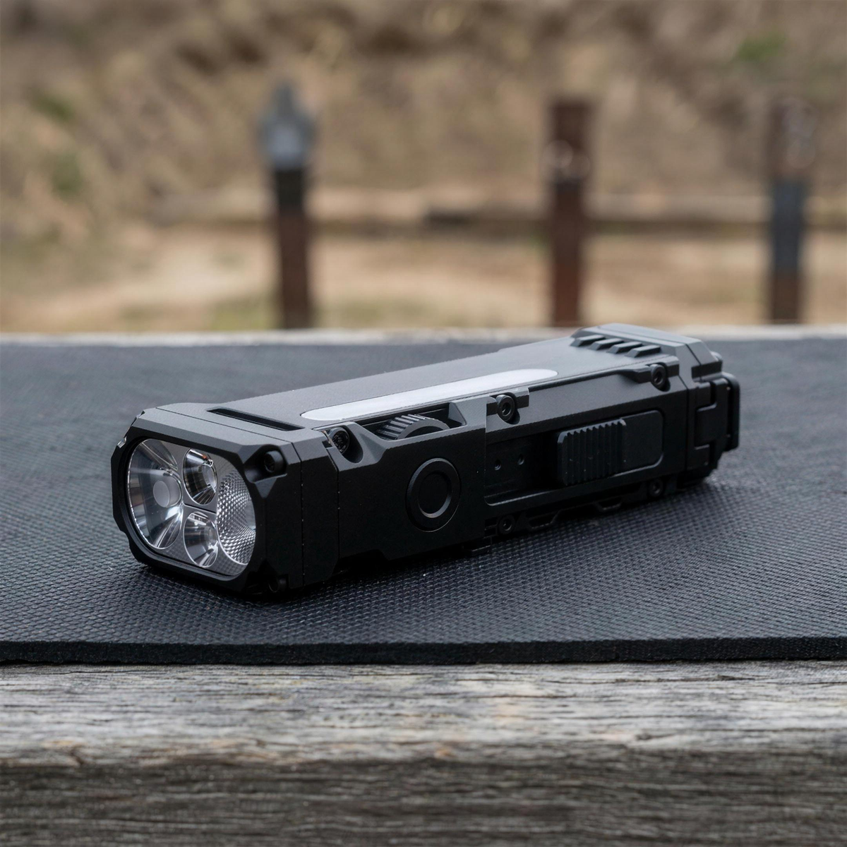 ICONTACTIC Compact Flat Flashlight, concept render pending supplier verification, switched off on an outdoor range bench